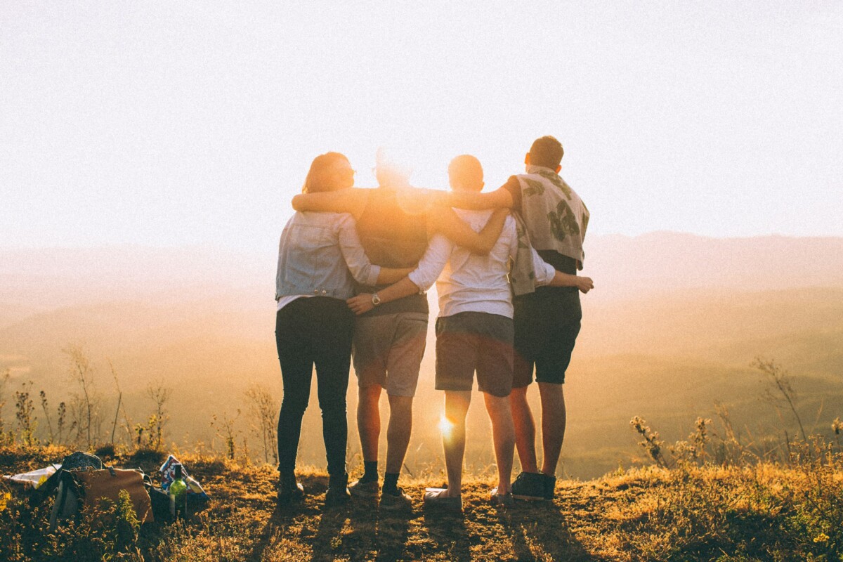 a family looking over a sunset after a hike